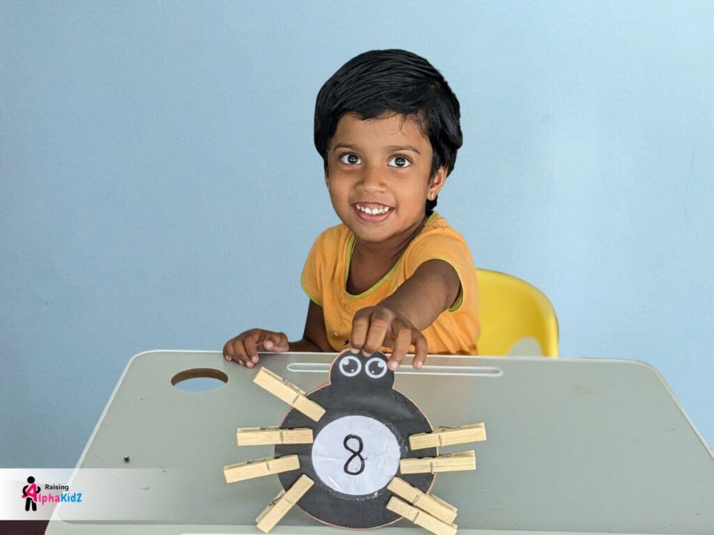 Preschooler kid identifying even numbers with symmetric clothespin legs on spider