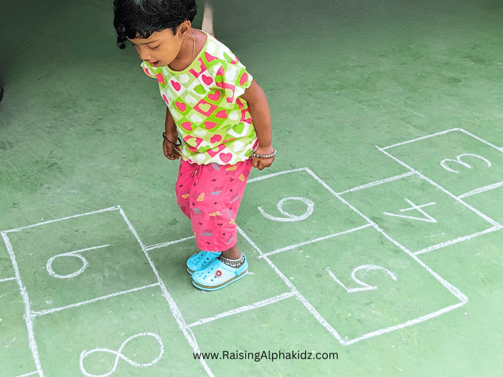 kid playing on hopscotch game