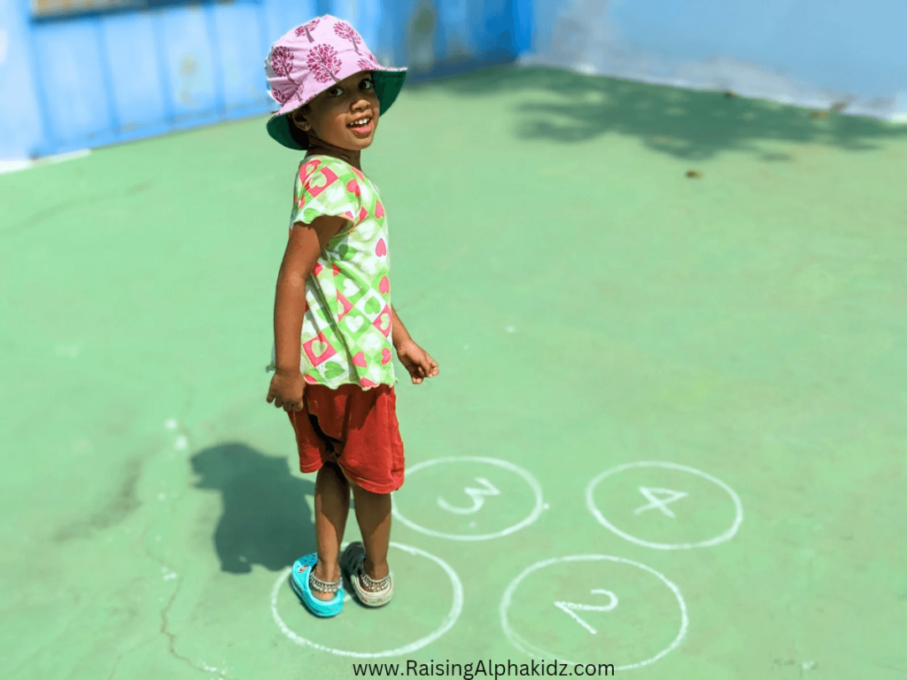 Child playing jumping game for pe