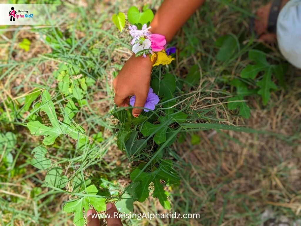 Child picking flowers for making nature bracelet