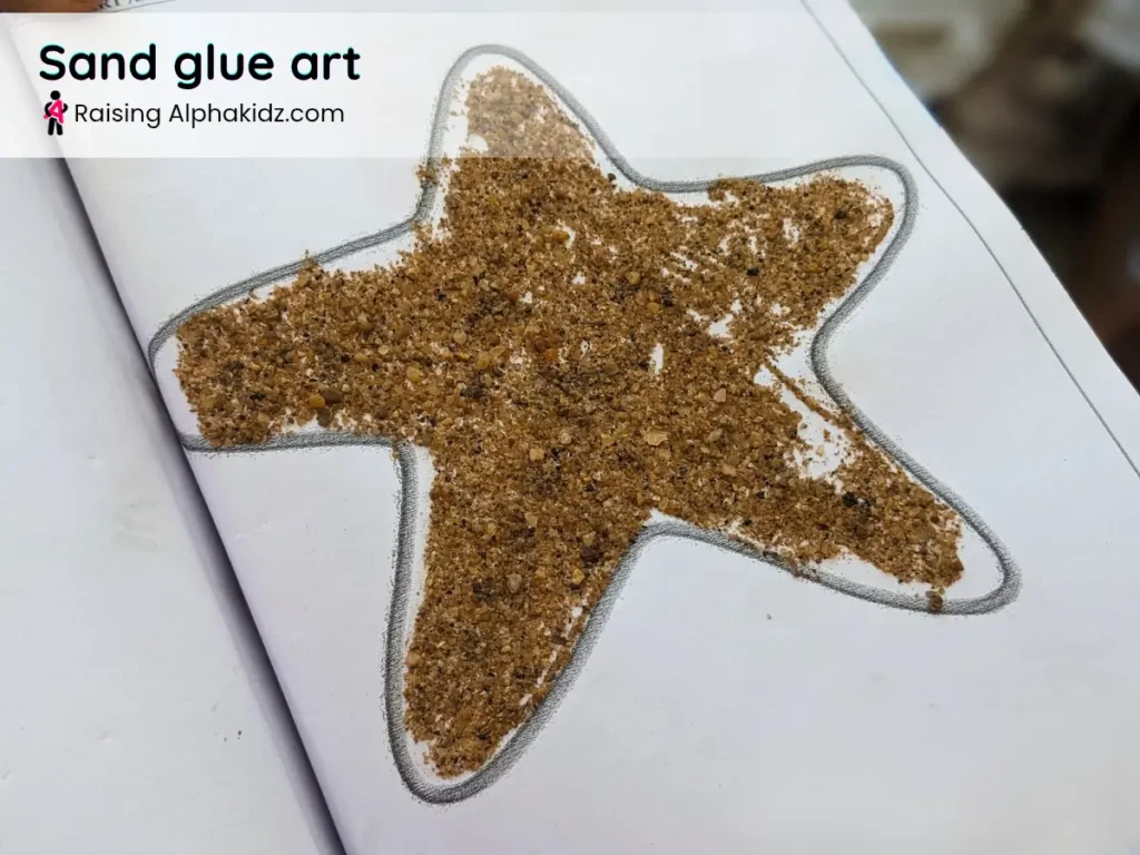 starfish craft decorated with sand in creative sand play activity