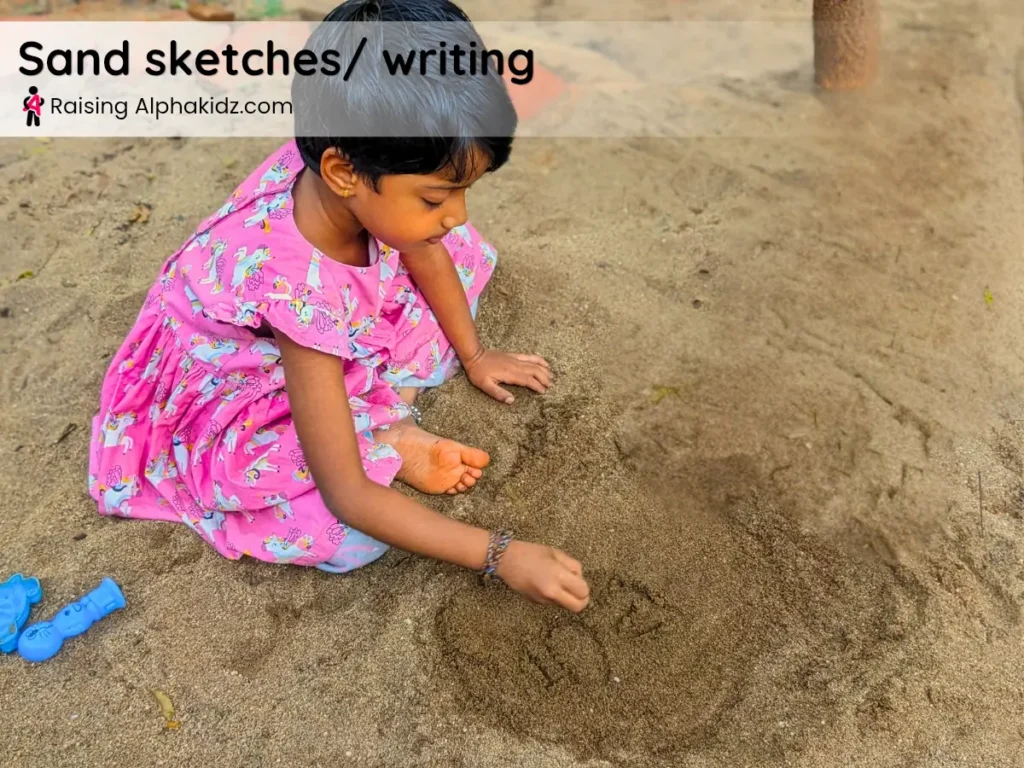 child practicing writing on flat sand surface during sand play