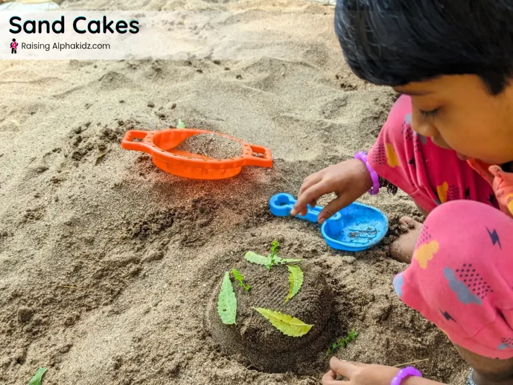 child making sand cake decorated with leaves in pretend sand play