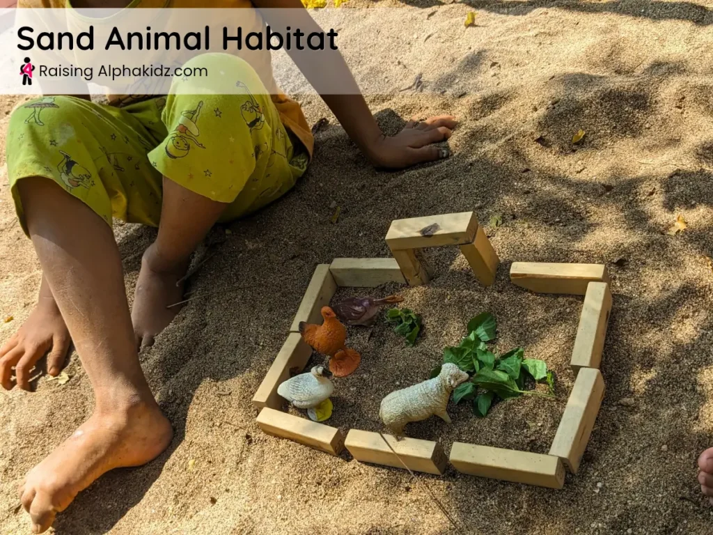 kid created a mini farm world with animals and wooden blocks on sand