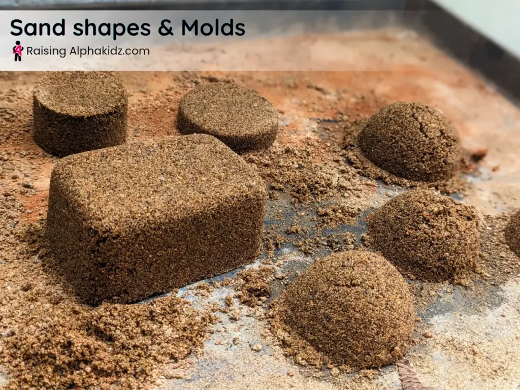 sand molded into geometric shapes during sand play activities