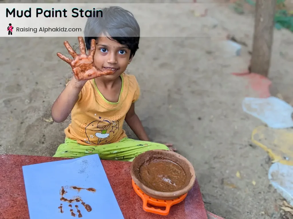 kids hands showing brown mud stains after mud painting