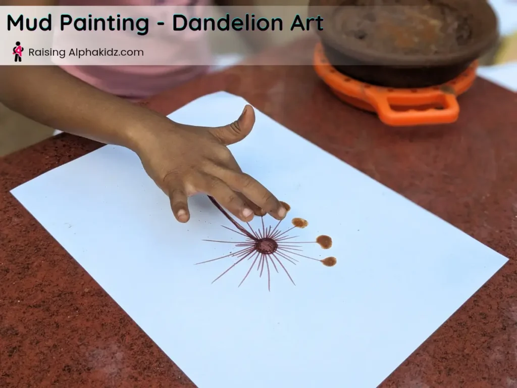 kids hand making mud dandelion with fingerprint dots for mud painting