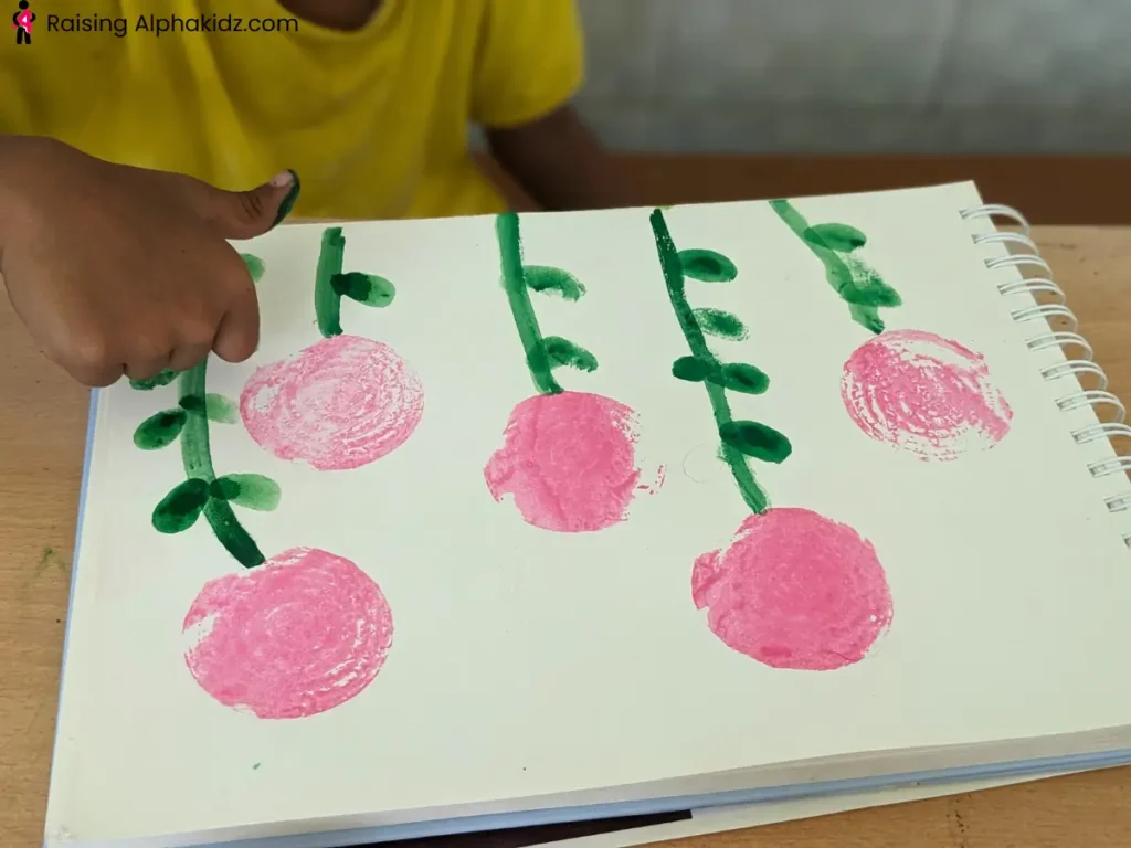 onion stamp art flowers with green stems painted after onion printing activity