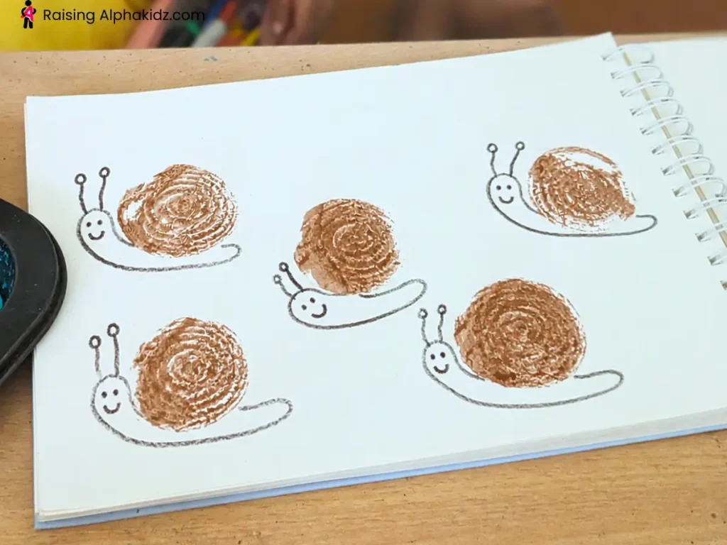 onion stamp art snail craft using brown onion printing and simple drawing