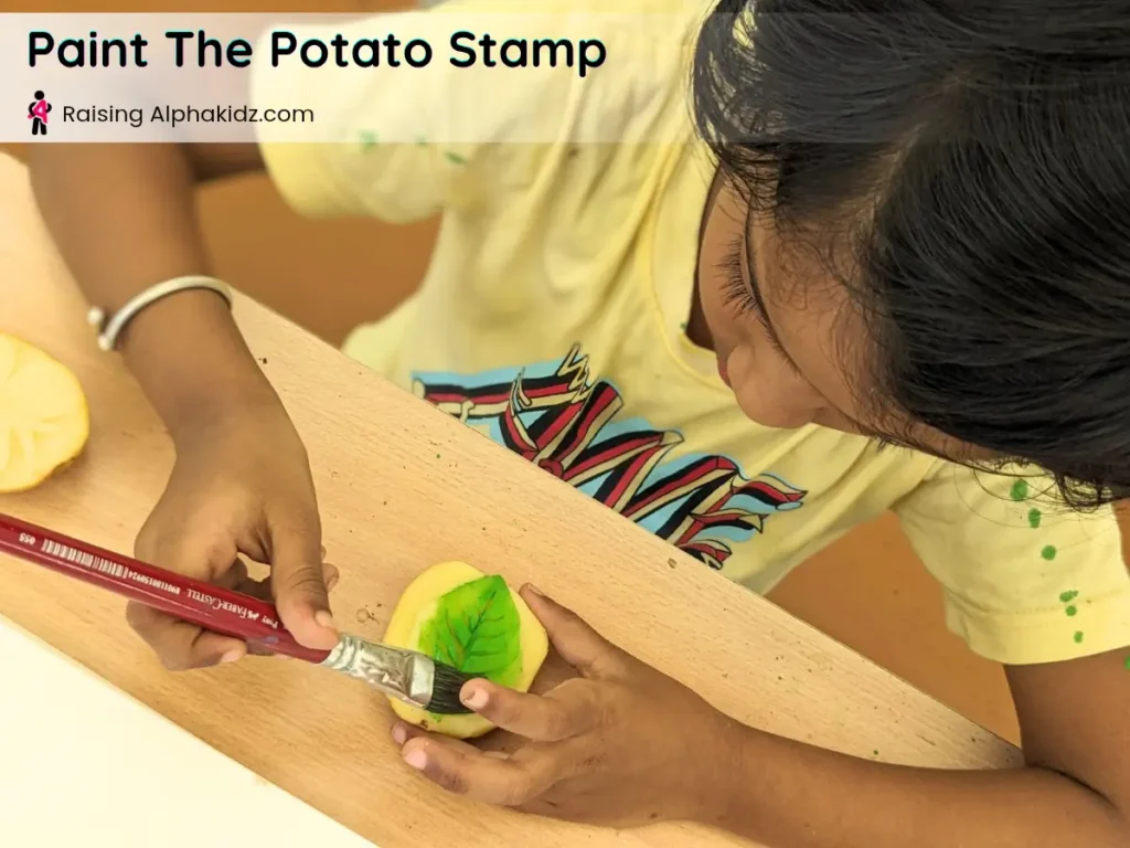 painting the leaf potato stamp surface with a brush