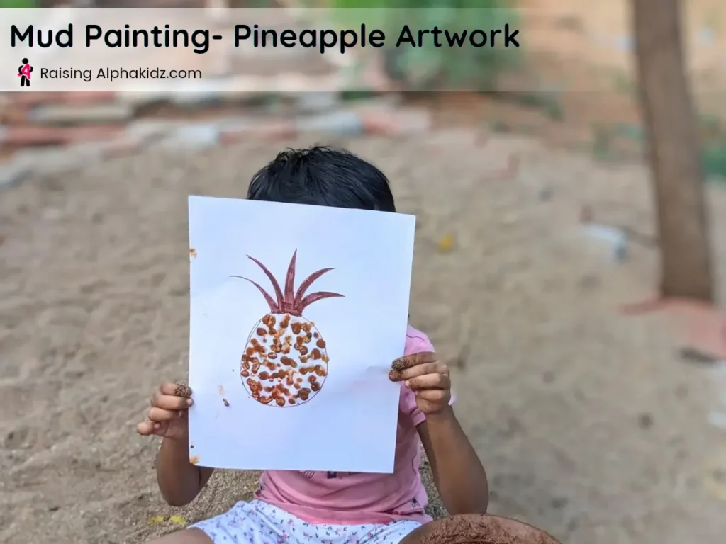kid showing completed pineapple mud painting artwork