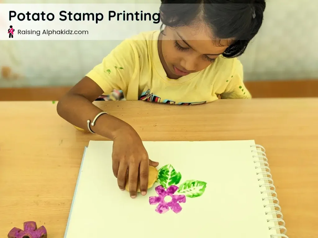 making a leaf impression on paper with potato stamp