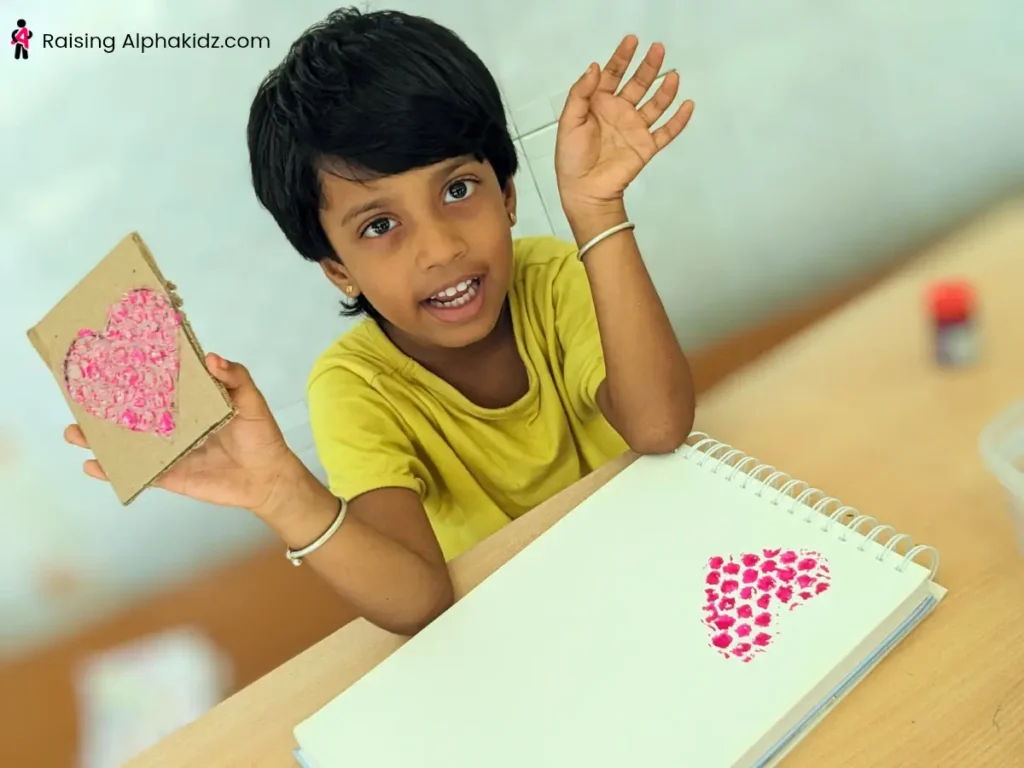 A kid making heart art using the bubble wrap art