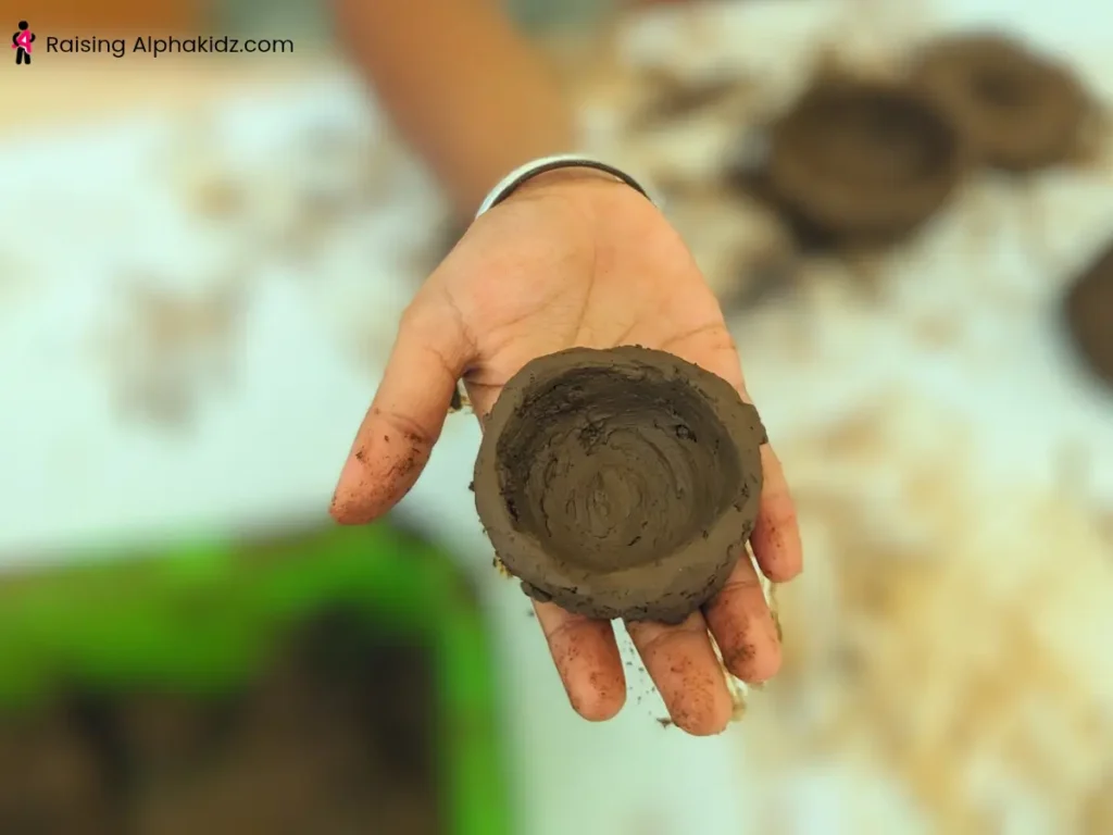 Hand-shaped clay pinch pots made without tools or a pottery wheel