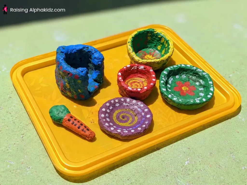 Finished colorful painted clay pinch pots displayed together