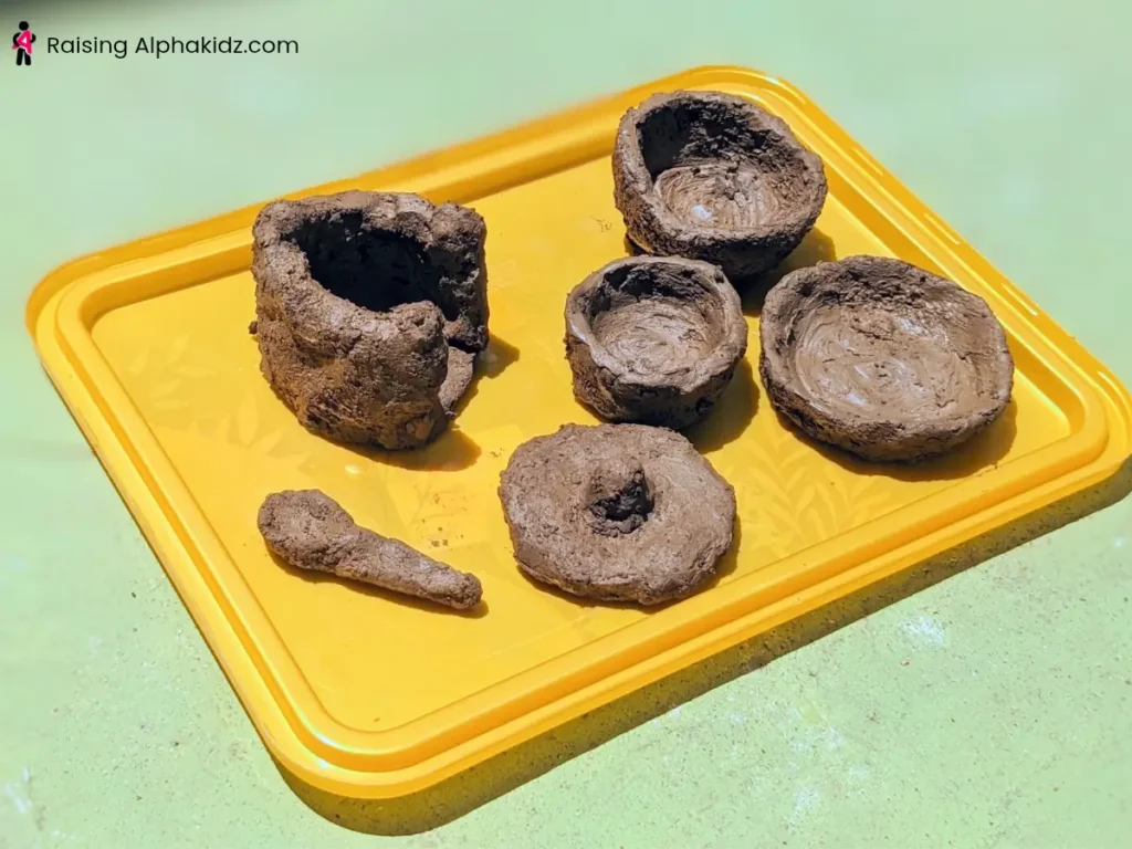 Handmade clay pinch pots drying in natural sunlight