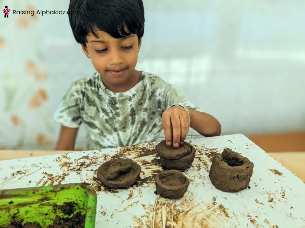 Assorted clay models including bowls, plates, and mini pots made by kids