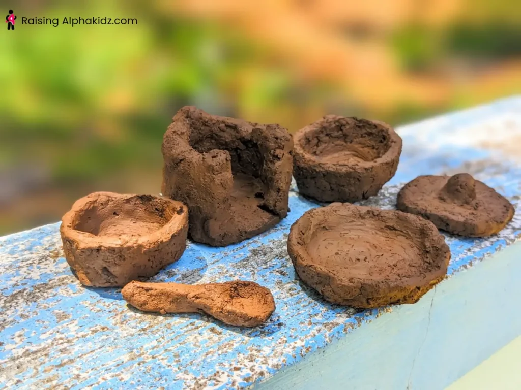 Multiple air-dried clay pinch pots ready for painting