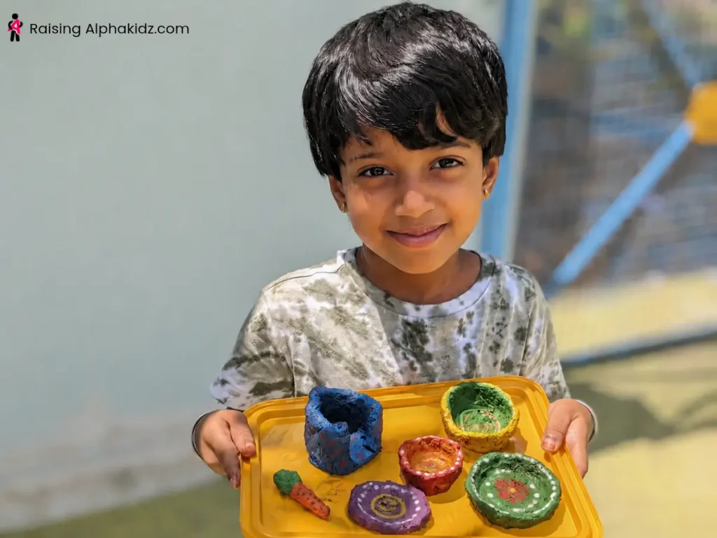 Child painting dried clay pinch pots with acrylic colors