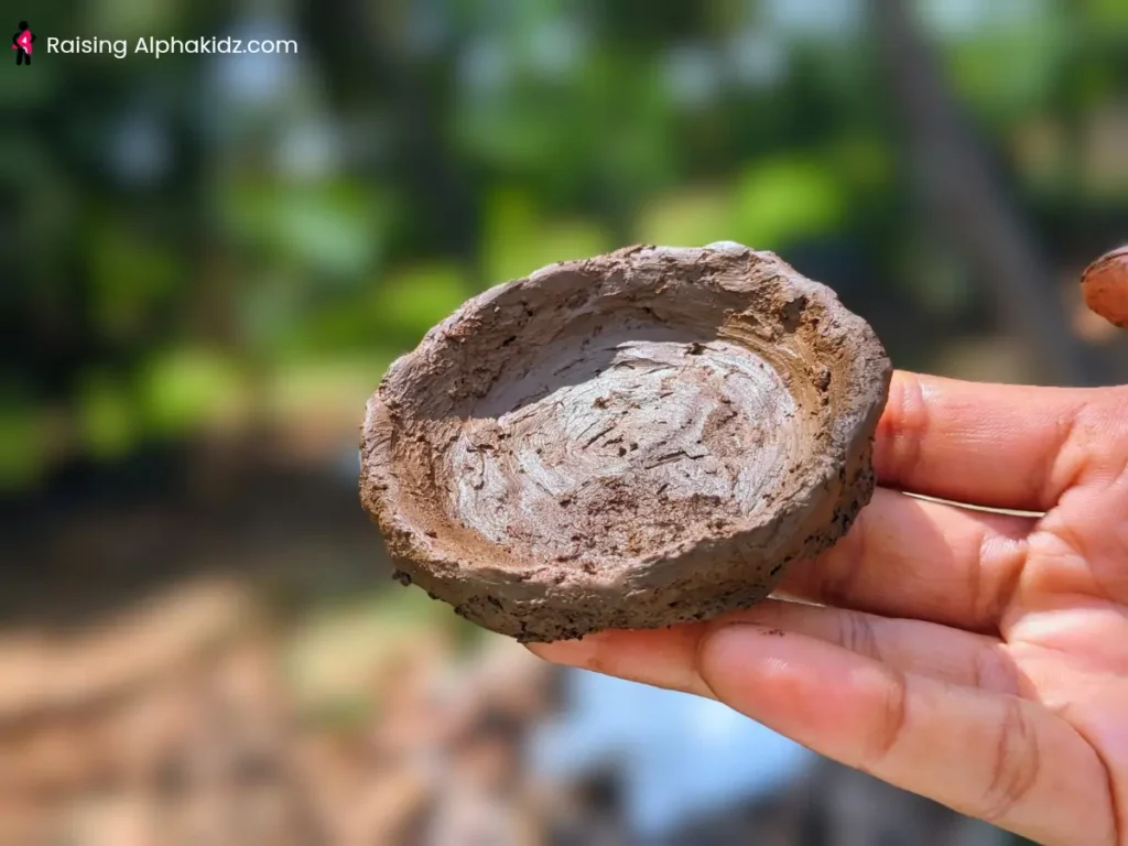 Flat wide clay pinch plate shaped by a child's hands