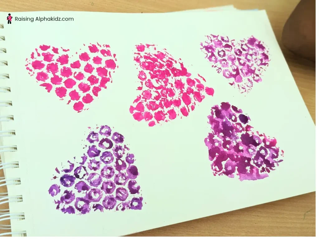 Multiple bubble wrap art - heart prints made on a canvas
