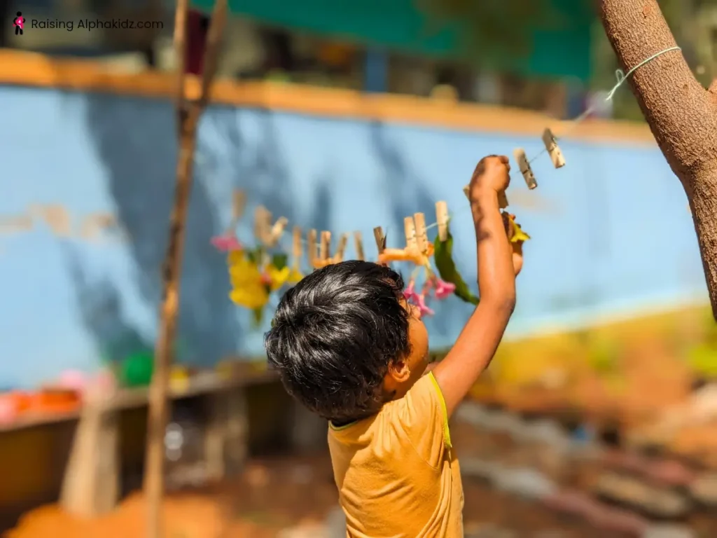 Kid fixing the leaves and flowers to a string  