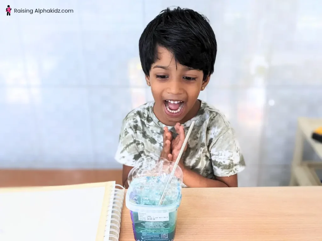 Kid enjoying the process of making soap bubbles to make bubble art