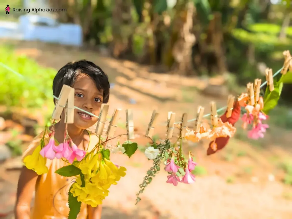 Kid posing for photograph after making her diy simple nature garland 